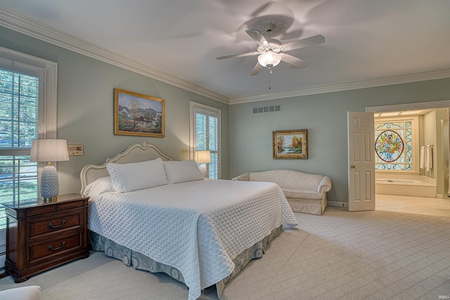 carpeted bedroom with ceiling fan, crown molding, and ensuite bathroom