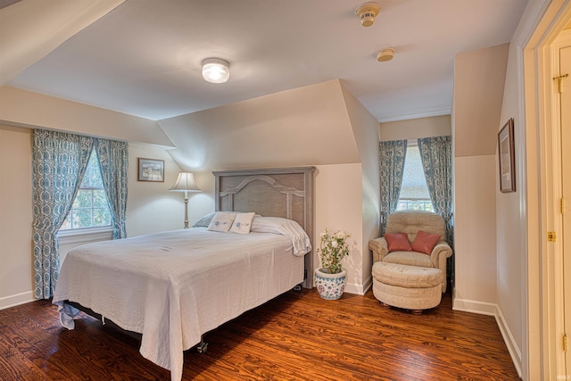 bedroom featuring dark wood-type flooring and vaulted ceiling