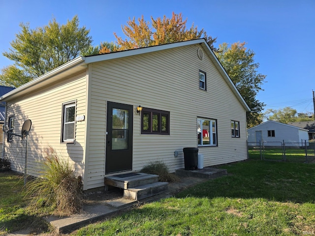 back of house with a lawn