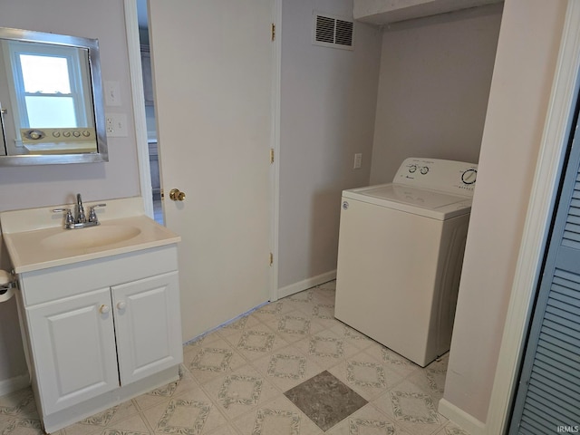 clothes washing area with sink and washer / clothes dryer