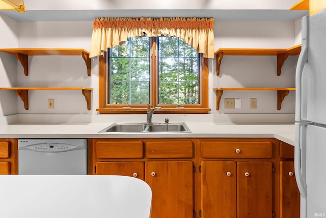 kitchen featuring white appliances and sink