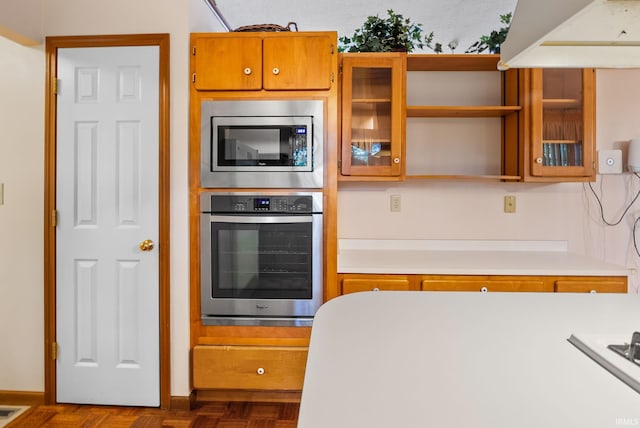 kitchen featuring appliances with stainless steel finishes and dark parquet floors