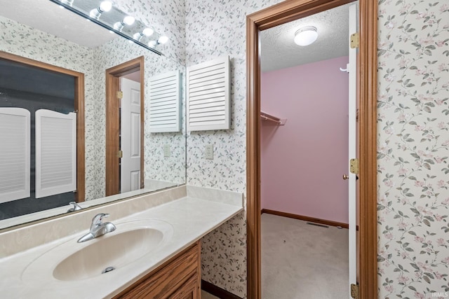 bathroom featuring vanity and a textured ceiling