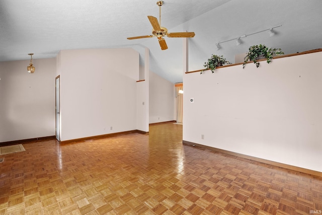 empty room with ceiling fan, a textured ceiling, parquet floors, and high vaulted ceiling