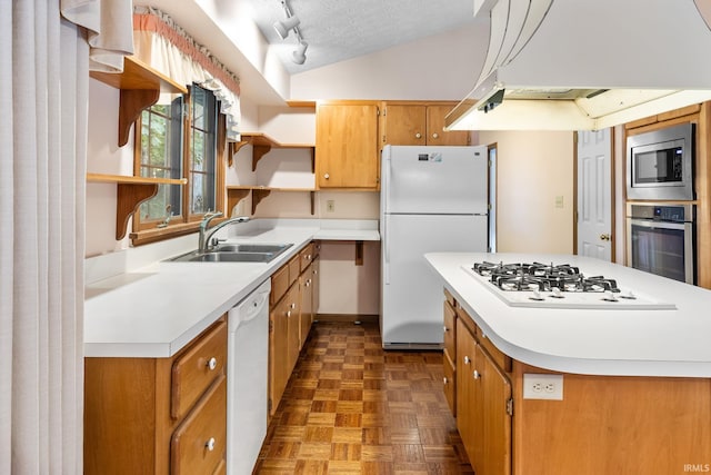 kitchen with sink, a textured ceiling, stainless steel appliances, dark parquet flooring, and vaulted ceiling