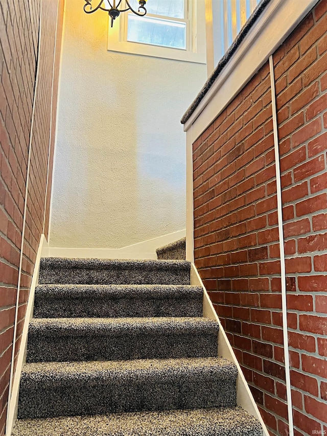 staircase with brick wall