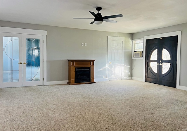 foyer featuring ceiling fan, french doors, and carpet