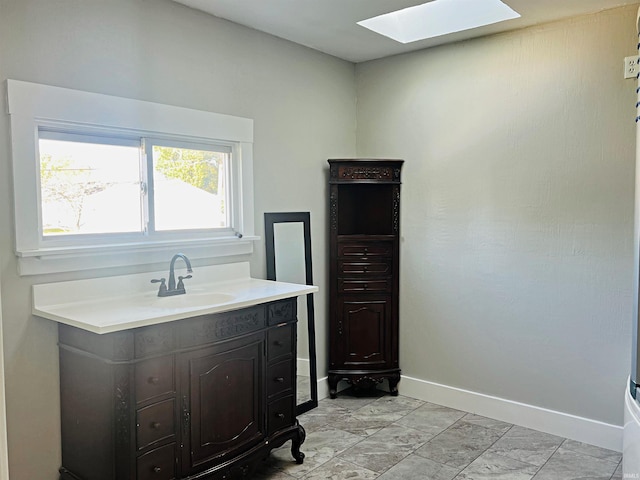 bathroom with a skylight and vanity