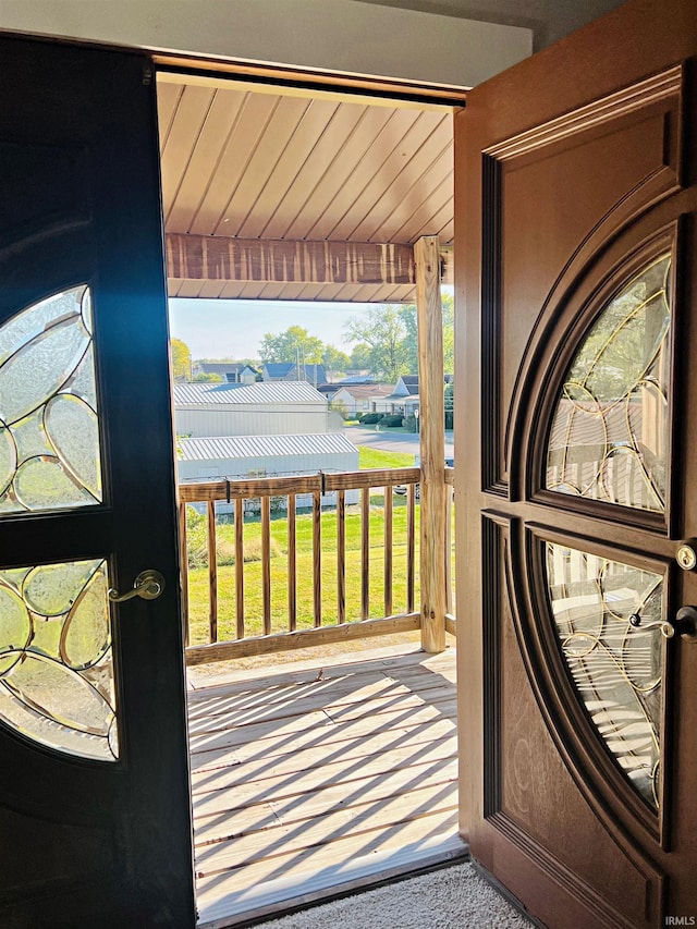 doorway to outside featuring carpet floors