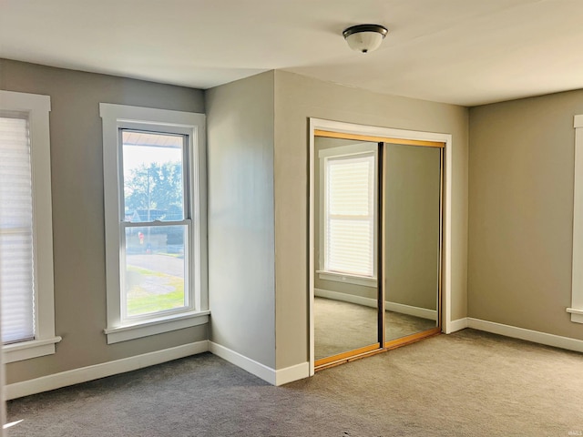 unfurnished bedroom featuring a closet and carpet flooring