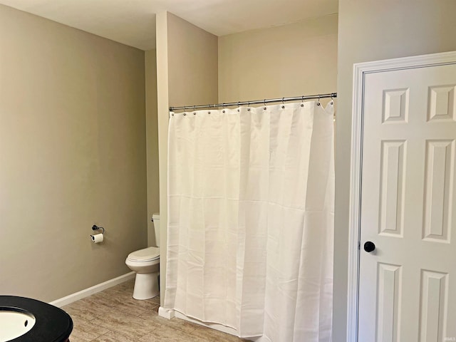 bathroom with walk in shower and toilet