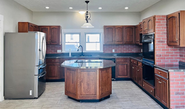 kitchen with a kitchen island, hanging light fixtures, sink, backsplash, and black appliances