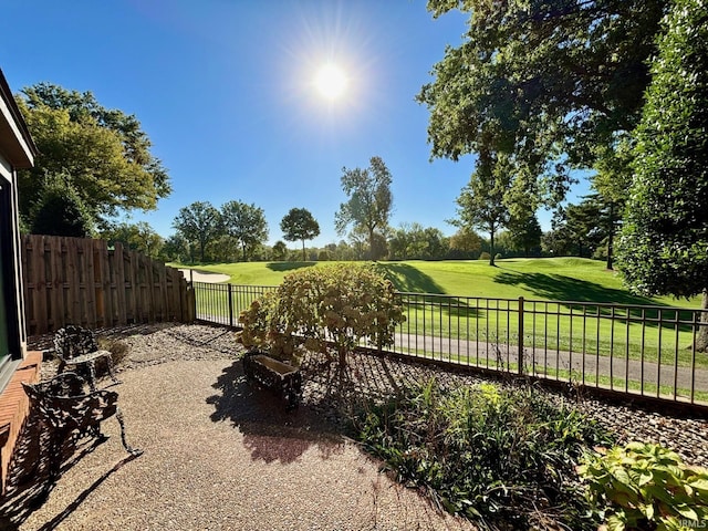 view of community featuring a fenced backyard and a yard