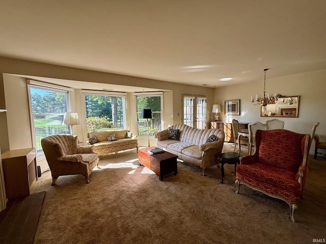 living room with an inviting chandelier, carpet, and a wealth of natural light