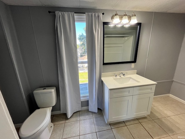 bathroom with tile patterned floors, vanity, and toilet