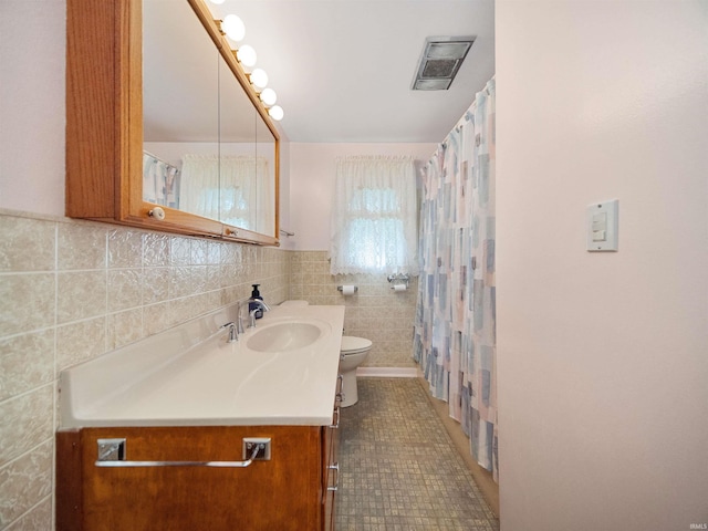 bathroom featuring tile walls, tile patterned floors, vanity, and toilet