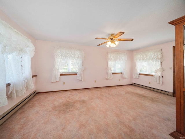 carpeted empty room featuring ceiling fan and a baseboard radiator