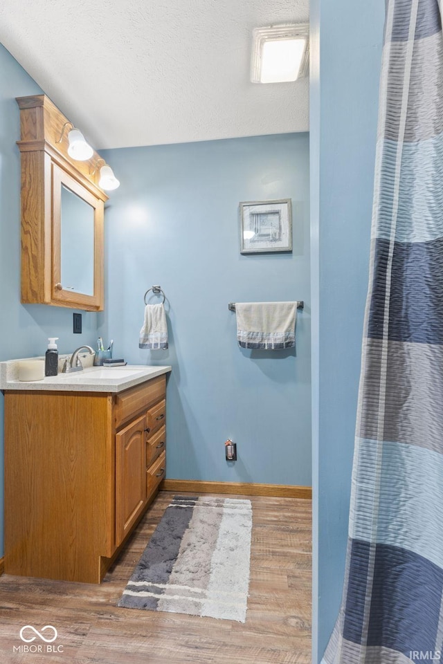 bathroom with vanity and hardwood / wood-style floors