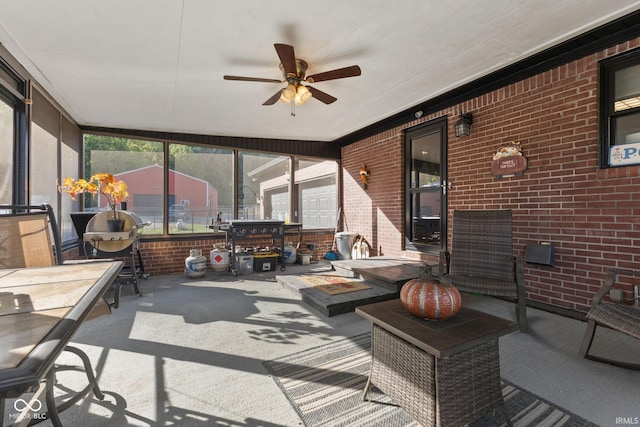 sunroom featuring ceiling fan