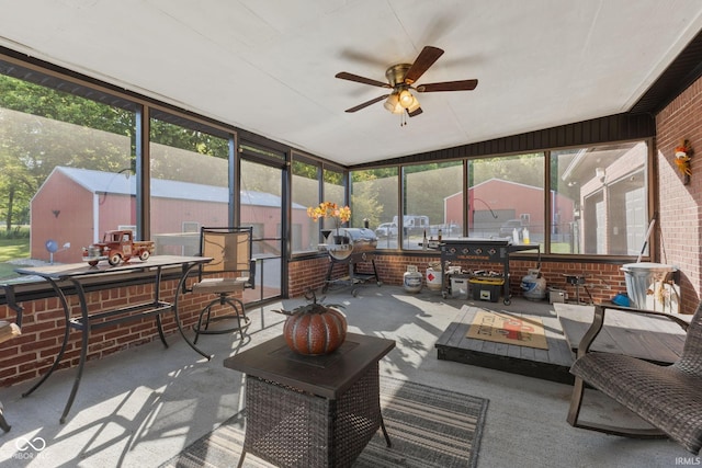 sunroom with a wealth of natural light and ceiling fan