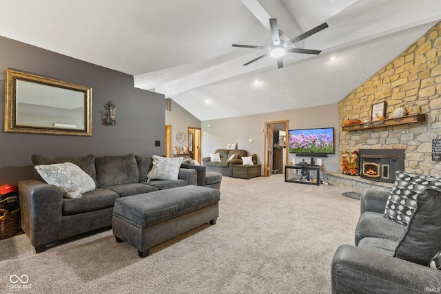 carpeted living room featuring a stone fireplace, lofted ceiling with beams, and ceiling fan