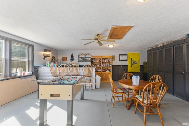 recreation room featuring ceiling fan and a textured ceiling