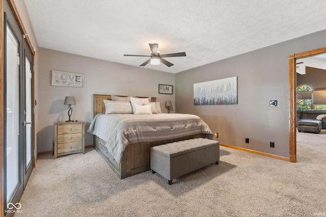 carpeted bedroom featuring a textured ceiling and ceiling fan