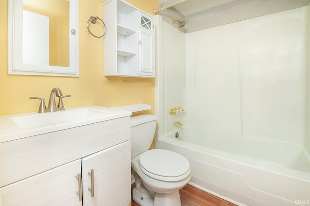 full bathroom featuring  shower combination, vanity, wood-type flooring, and toilet