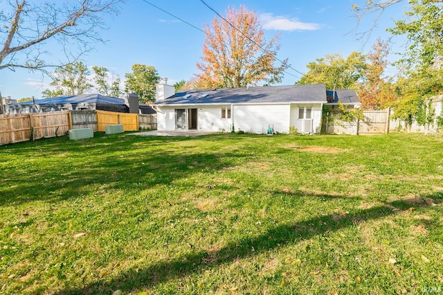 back of property featuring a yard and a patio area