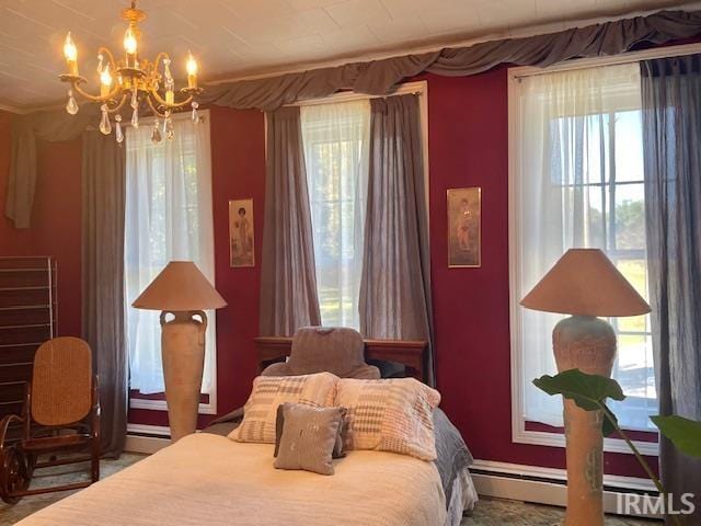 bedroom with a notable chandelier and a baseboard heating unit