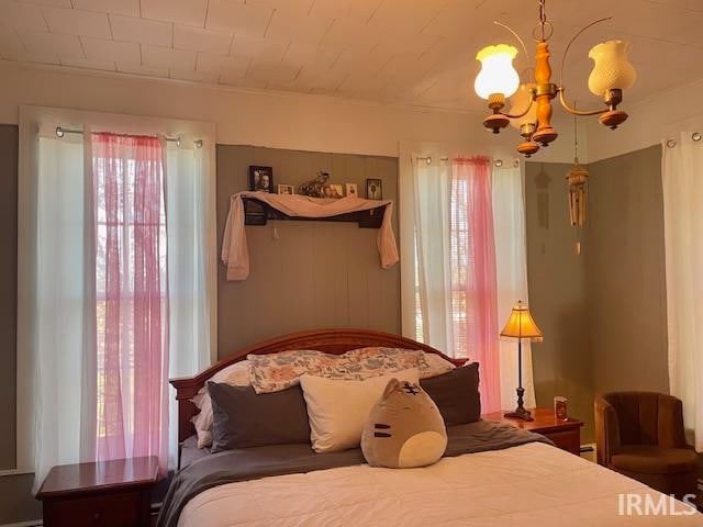 bedroom with a notable chandelier