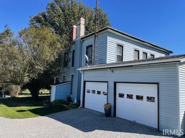 view of side of property with a garage