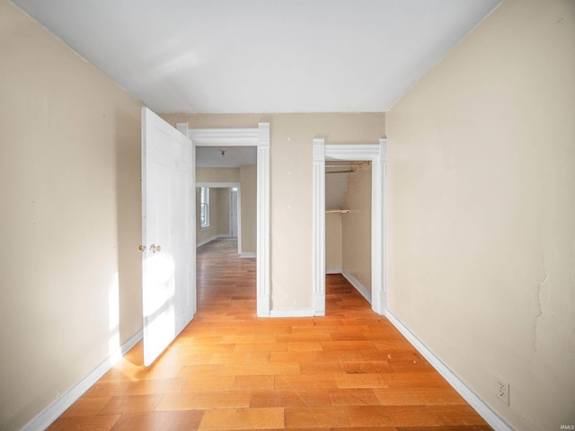 hallway with light hardwood / wood-style floors