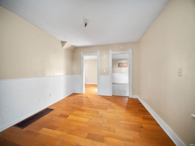 spare room with light hardwood / wood-style flooring