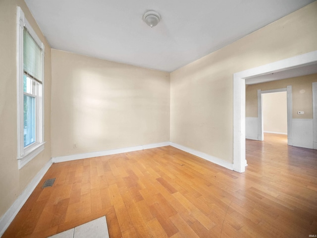 unfurnished room with light wood-type flooring