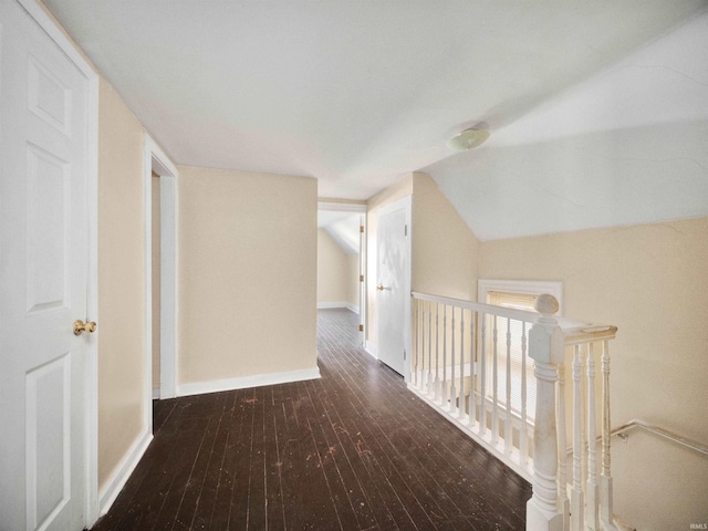 corridor featuring dark wood-type flooring and lofted ceiling