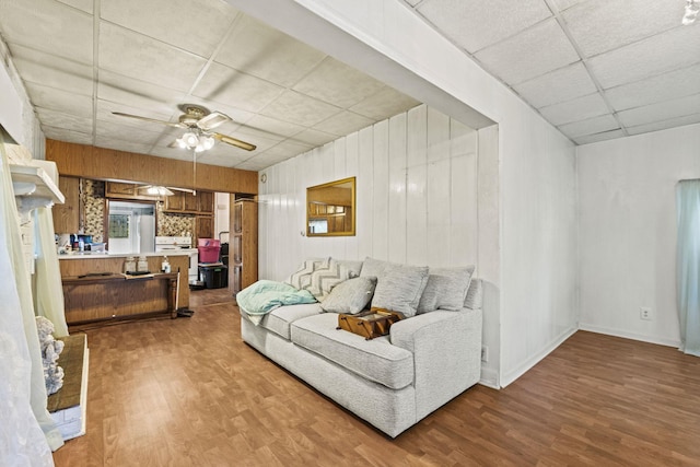 6885 N 315 E, Howe, IN 46746 - living area featuring baseboards, ceiling fan, a drop ceiling, and wood finished floors
