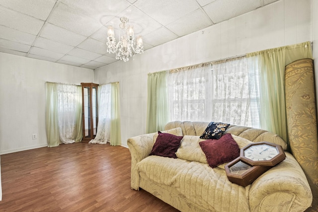 6885 N 315 E, Howe, IN 46746 - living area featuring wood finished floors, baseboards, a chandelier, and a paneled ceiling