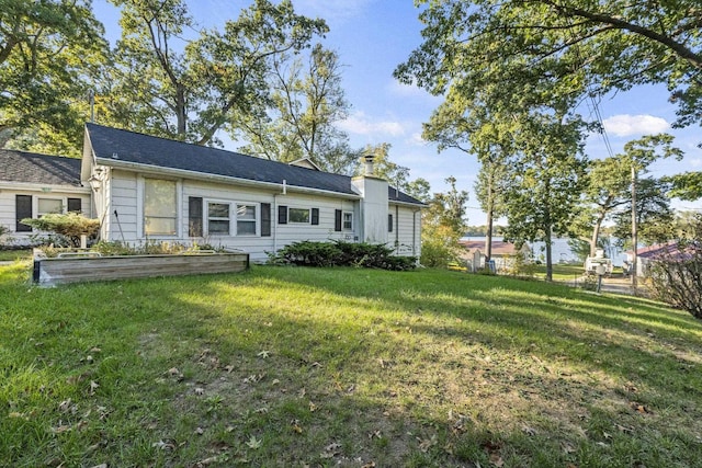 6885 N 315 E, Howe, IN 46746 - rear view of house featuring a lawn, fence, and a vegetable garden
