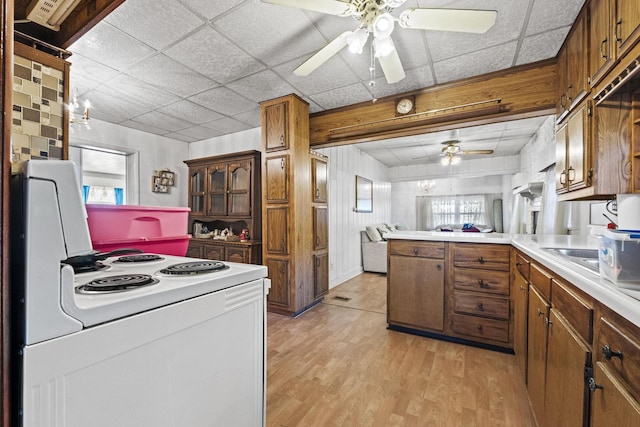 6885 N 315 E, Howe, IN 46746 - kitchen featuring a peninsula, ceiling fan, light wood-type flooring, brown cabinets, and white electric stove