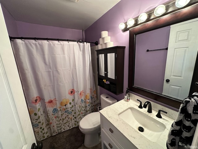 bathroom with vanity, curtained shower, and toilet