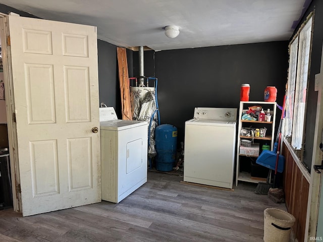 laundry area featuring washing machine and dryer and light hardwood / wood-style floors