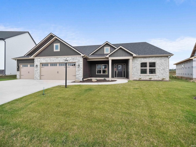 craftsman house featuring a front yard and a garage