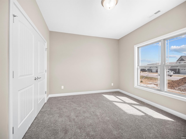 unfurnished bedroom with a closet and carpet