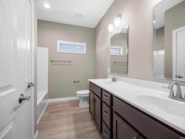 bathroom featuring hardwood / wood-style floors, vanity, and toilet