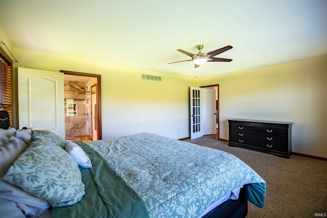 carpeted bedroom with ceiling fan and ensuite bath