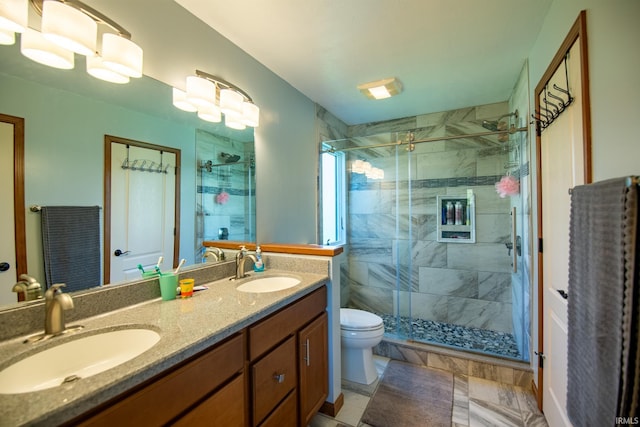 bathroom featuring toilet, tile patterned flooring, an enclosed shower, and vanity