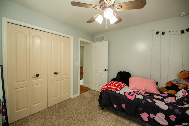 carpeted bedroom featuring ceiling fan and a closet