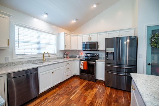 kitchen featuring high vaulted ceiling, dark hardwood / wood-style floors, sink, white cabinetry, and appliances with stainless steel finishes