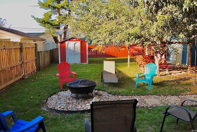 view of yard featuring a fire pit and a storage shed